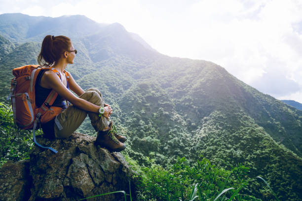 istock Young woman backpacker enjoy the view at mountain peak 1168946173