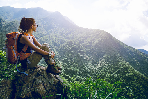 Young woman backpacker enjoy the view at mountain peak