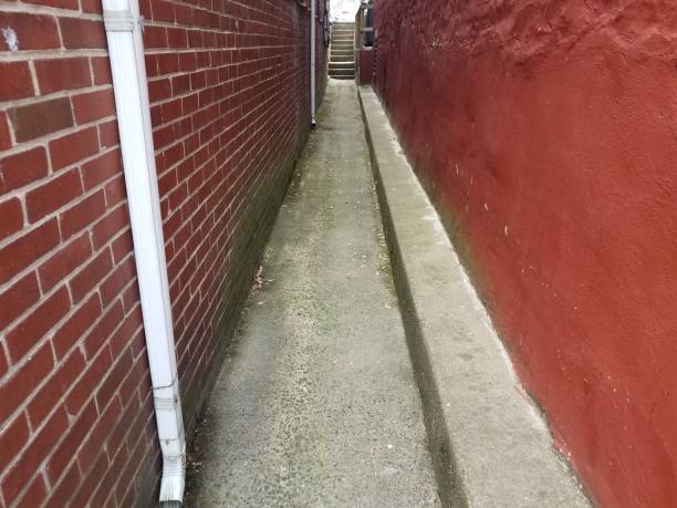 istock narrow alley with red wall and bricks on masonry 1168946459