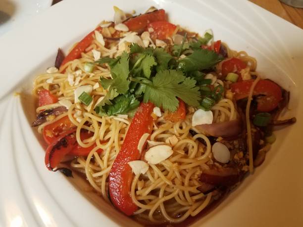 istock asian noodles with red peppers and cilantro and nuts 1168946472