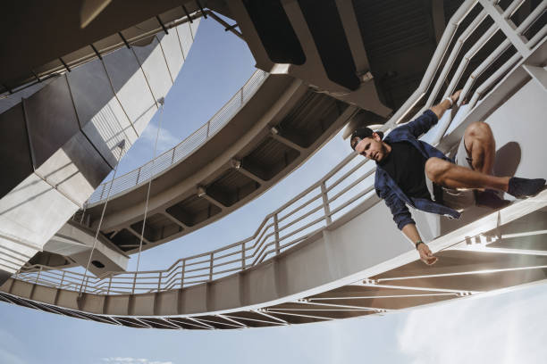 istock Freerunning athlete is hanging on the bridge and getting ready for a dangerous jump 1168946554