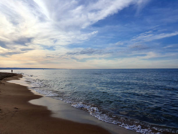 istock Calm waves on the beach at sunset 1168948236