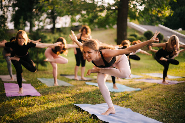 istock Group of young women are doing difficult yoga exercise standing on one leg 1168949413