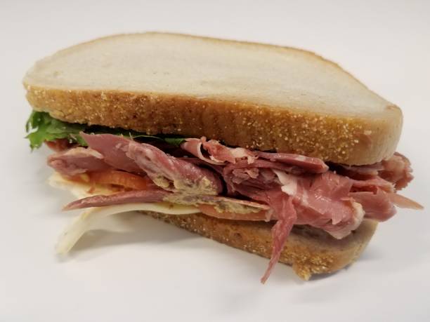 istock beef and cheese sandwich with mustard sauce on white desk 1168949476