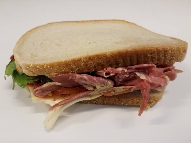 istock beef and cheese sandwich with mustard sauce on white desk 1168949537