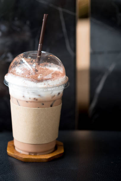 istock Iced coffee mocha with foam milk in takeaway cup on table 1168950810