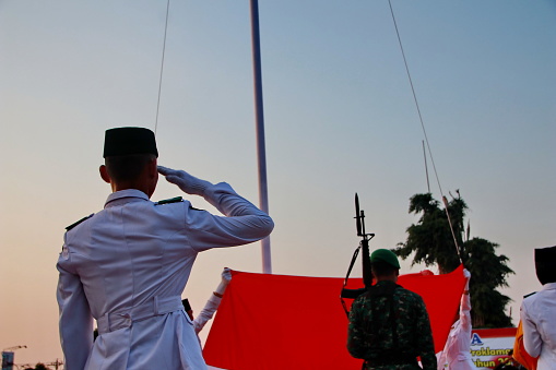 People gathered around the South African Flag.