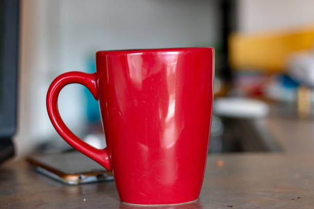 istock coffee mug in front of laptop. concept of working space 1168952900