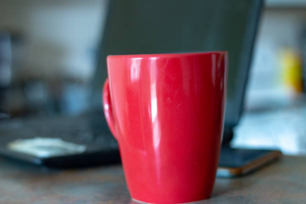 istock coffee mug in front of laptop. concept of working space 1168952902