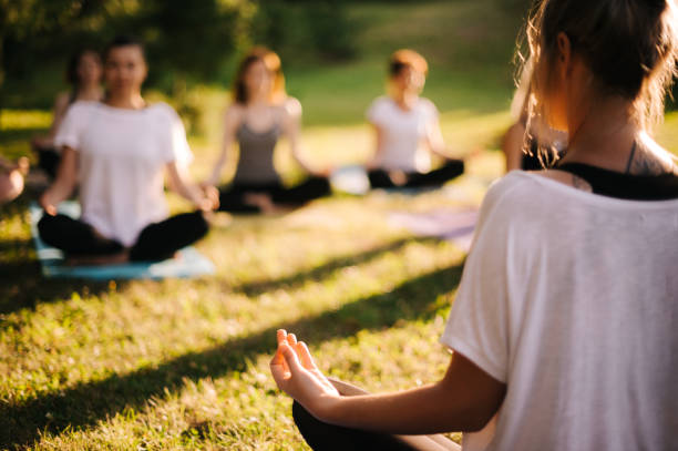 istock Group of young sporty woman practicing yoga lesson with instructor 1168953576
