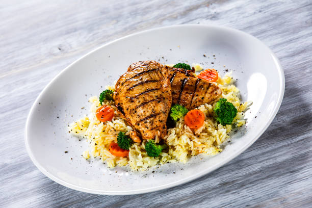 istock Roast chicken filets with rice and vegetables 1168953875