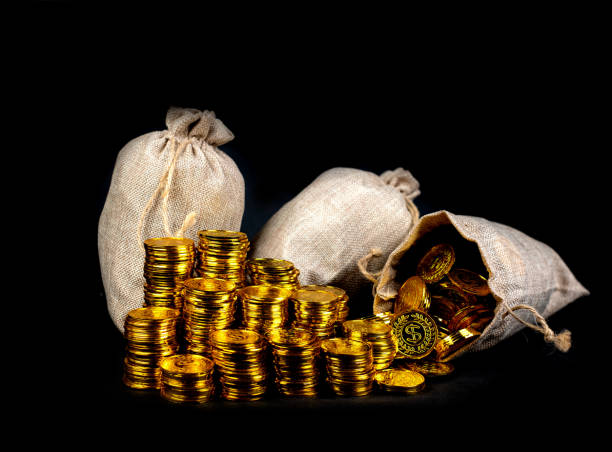 istock Stacking gold coin in treasure sack at black background 1168954193