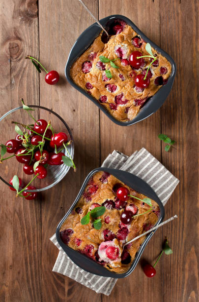 istock Cherry clafouti in portional ceramic forms on rustic wooden background. 1168955990