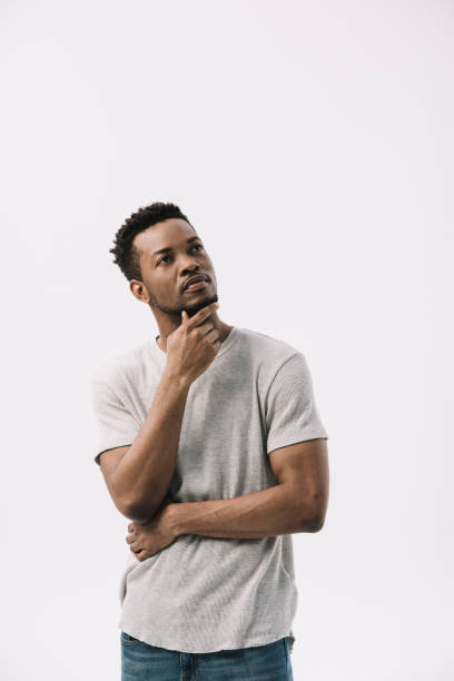istock pensive african american man standing and touching face isolated on white 1168956923