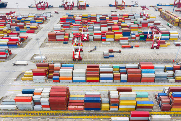 istock Logistics and transportation of Container Cargo ship and Cargo plane with working crane bridge in shipyard at sunrise, logistic import export and transport industry background 1168956949