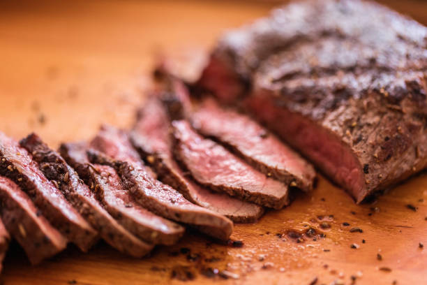 istock Grilled steak finely sliced at cutting board, close-up 1168957429