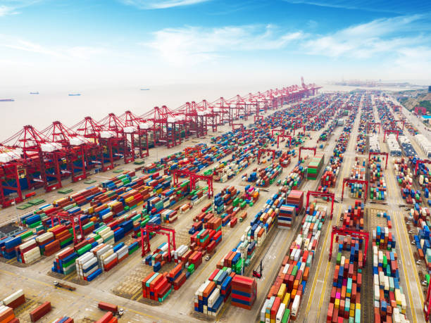 istock Logistics and transportation of Container Cargo ship and Cargo plane with working crane bridge in shipyard at sunrise, logistic import export and transport industry background 1168958032