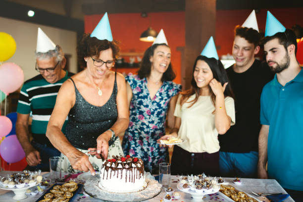 family celebrating a birthday party, and having fun - life events laughing women latin american and hispanic ethnicity imagens e fotografias de stock