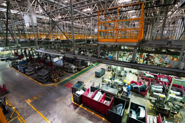 Modern automatic automobile manufacturing workshop. A busy car production line. Industrial scenery background.