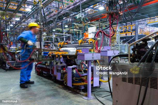 Modern Automatic Automobile Manufacturing Workshop A Busy Car Production Line Industrial Scenery Background Stock Photo - Download Image Now