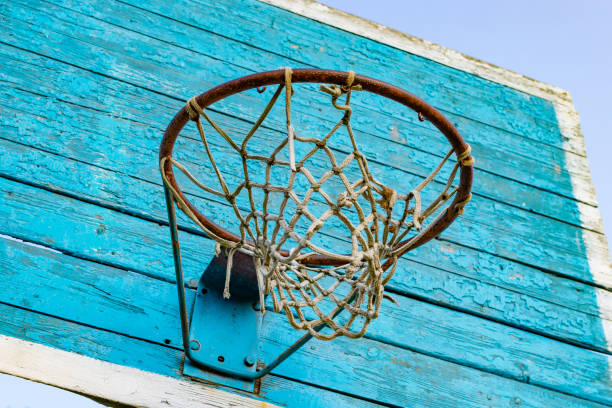 istock Rusty metal ring with basketball net and wooden shield 1168959580