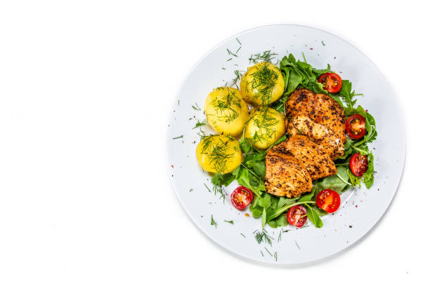 istock Grilled chicken breast and vegetables on wooden table 1168961523