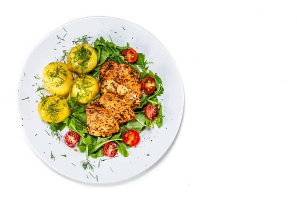 istock Grilled chicken breast and vegetables on wooden table 1168961526