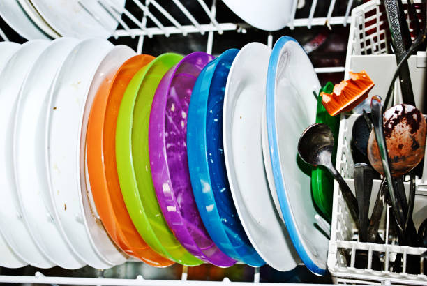 istock Domestic work: Colourful dirty dishes arranged in the dish washer 1168961709