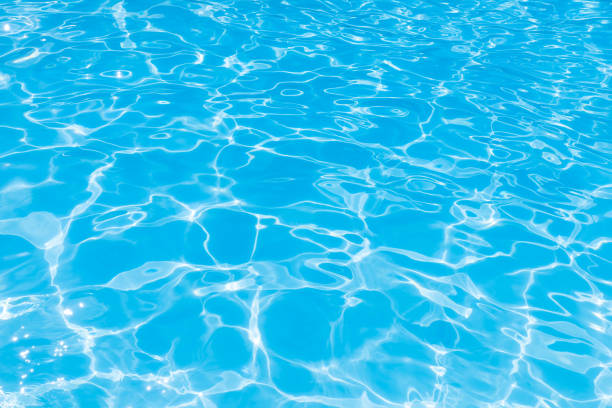 istock Blue water in pool for background and abstract, Ripple wave with sun reflection in swimming pool 1168962701