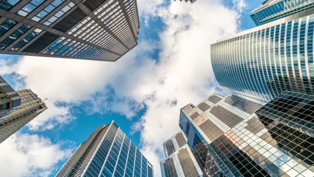 Time lapse Uprisen angle of Downtown Chicago skyscraper with reflection of clouds among high buildings, Illinois, United States, Business and Perspective concept, 4k clip