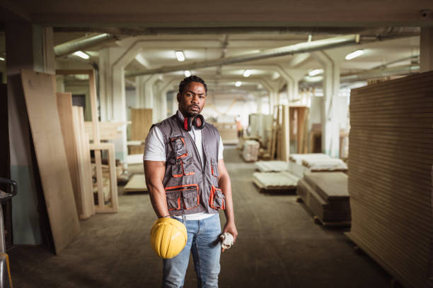 African American male carpentry worker African American male carpentry worker on the site helmet hardhat protective glove safety stock pictures, royalty-free photos & images