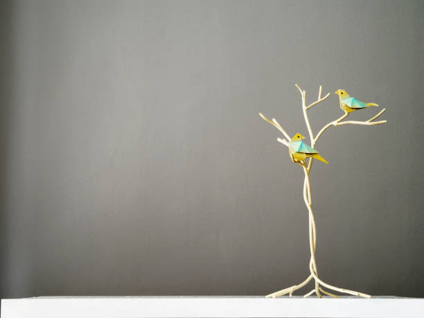 Table decoration with vintage metal birdsTwo colorful birds on a decorative metal tree