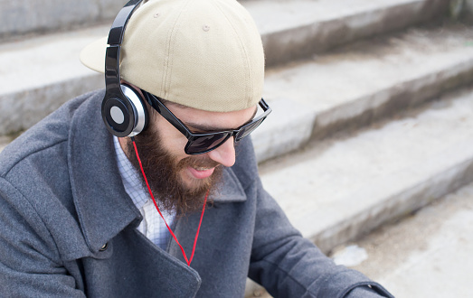 Handsome guy listening to music with heatset.