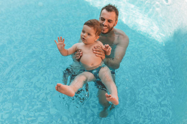 istock Dad learning toddler baby to swim 1168969338