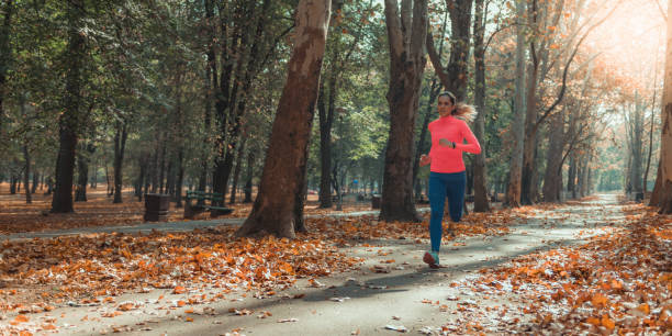 istock Woman Jogging Outdoors in Park 1168969450