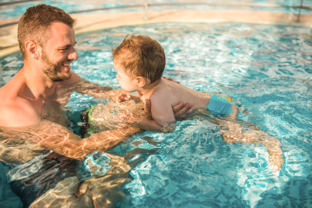 istock Dad learning toddler baby to swim 1168969494
