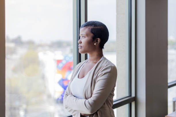 istock Businesswoman daydreaming while looking through window 1168969636