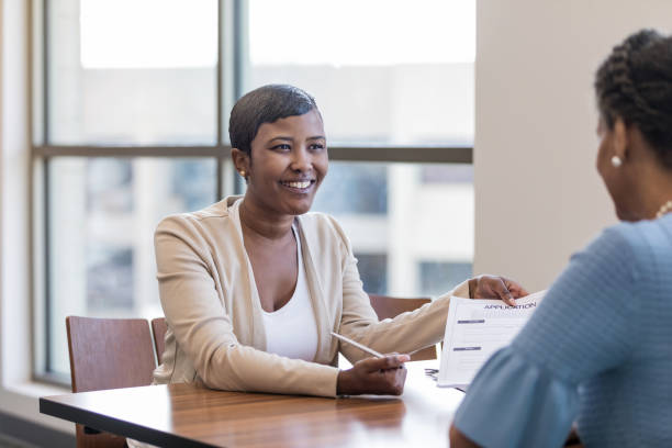 istock Confident loan officer gives loan application to customer 1168969653