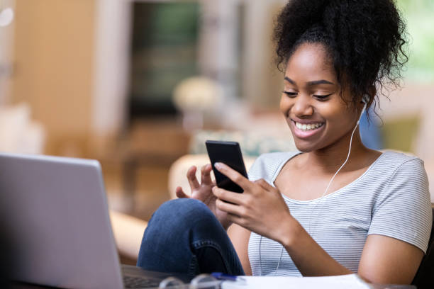 istock Young woman uses smartphone at home 1168969710