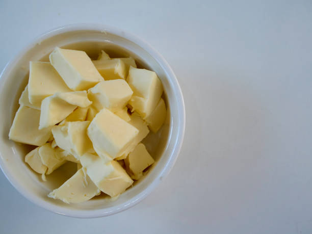 istock Butter pieces in bowl on on the table, close up 1168971208