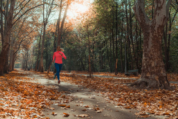 istock Woman Jogging Outdoors. Park, Nature 1168971458