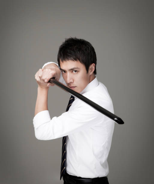 istock businessman holding a wooden sword. 1168972326