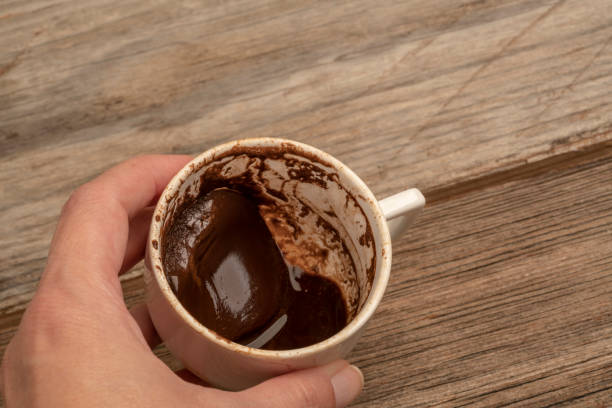 istock hand holding a cup of coffee in order to fortune telling 1168972985