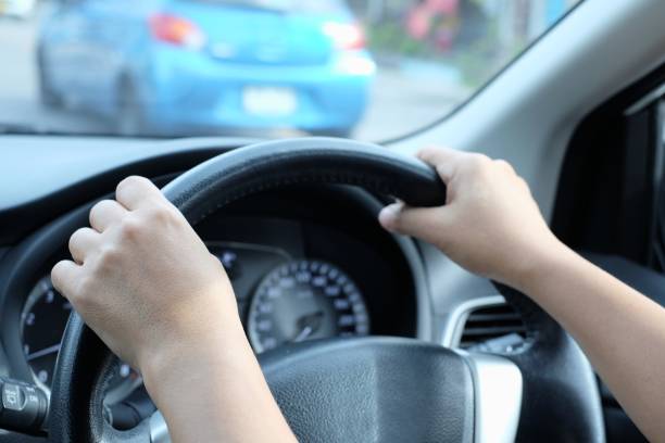 istock Hands on the steering wheel while driving on the road 1168973416
