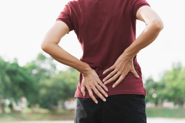 istock A woman suffering from backache, spinal injury and muscle issue problem at outdoor. 1168975815