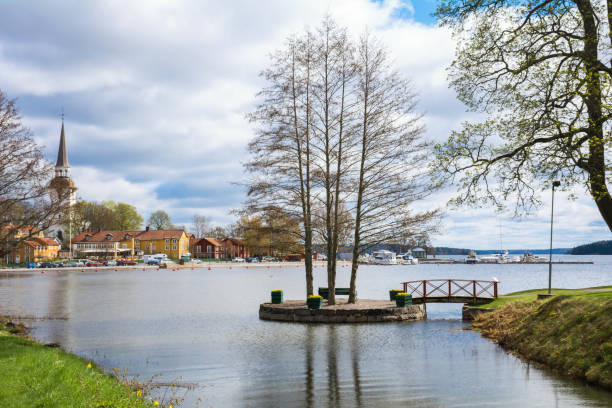 Central part of small and cosy swedish town Mariefred in Sodermanland with its harbour and high bell tower of local church (Mariefred Charterhouse) Panorama, urban landscape