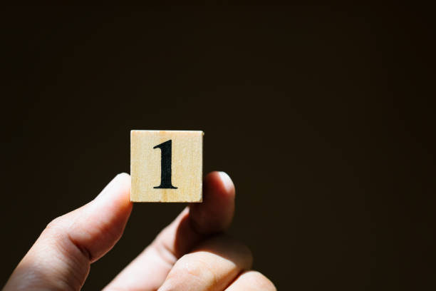 istock Hand hold wooden block number one 1168976150