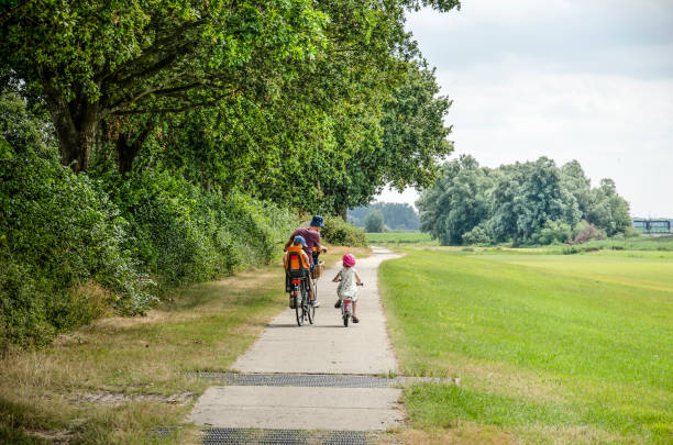 bicycling with the kids - polder field meadow landscape imagens e fotografias de stock