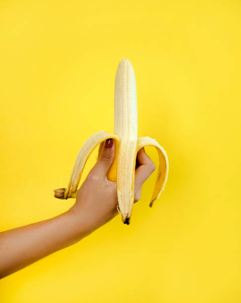 istock Woman hand with banana 1168981263