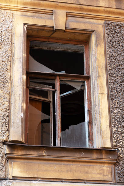 istock broken glass in the window of an abandoned old town house 1168982425